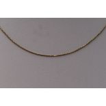 A yellow metal box chain stamped 10K, approx 20' & 2.3g