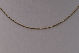 A yellow metal box chain stamped 10K, approx 20' & 2.3g