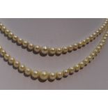 A double string of graduated cultured pearls having a pearl and amethyst set 9ct rose gold box