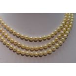A mid 20th Century triple row cultured pearl necklace, each pearl of even form having decorative
