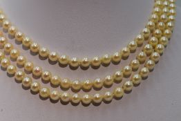 A mid 20th Century triple row cultured pearl necklace, each pearl of even form having decorative