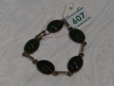 A five stone Jade style cabouchon bracelet in collared mounts with HM silver interconnecting bars
