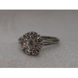 A lady's dress ring having a diamond cluster, total approx 1ct in a raised claw set basket mount