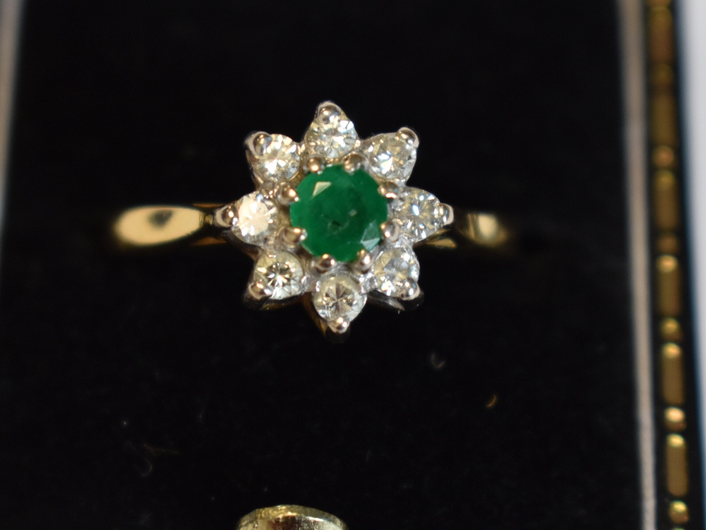 A lady's dress ring having an emerald and diamond cluster in a claw set mount on an 18ct gold - Image 5 of 8