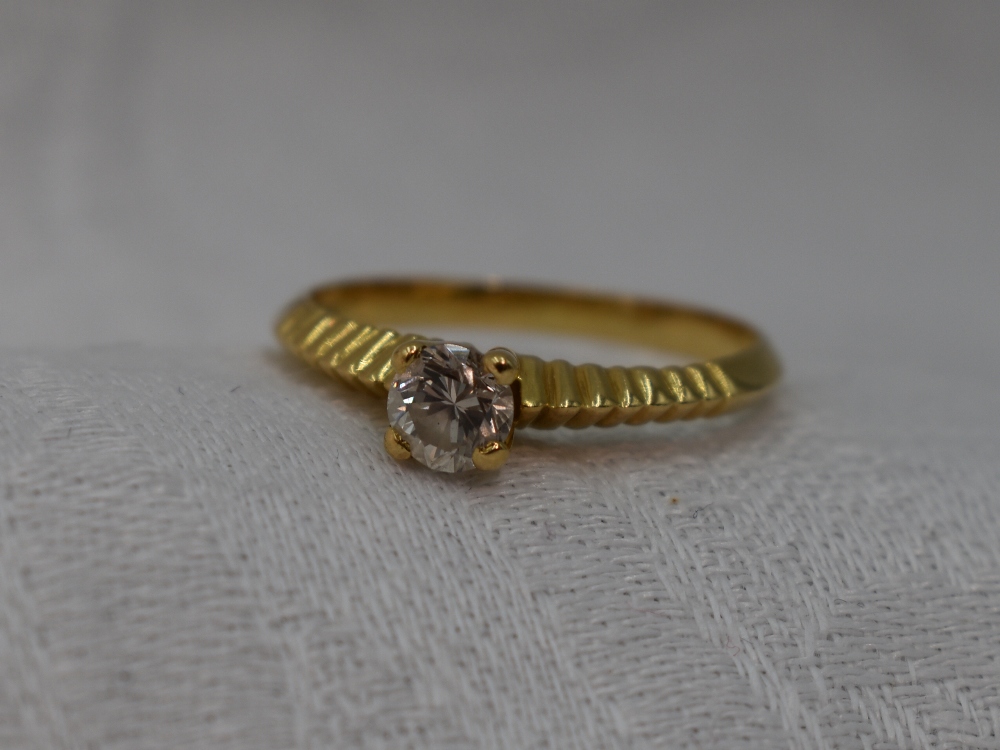 A lady's dress ring having a diamond solitaire, approx 0.40ct in a four claw raised setting to