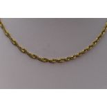 A yellow metal open rope chain stamped 750, approx 18' & 4.7g