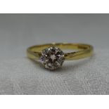 A lady's diamond solitaire dress ring, approx 0.75ct in a claw set mount to raised shoulders on an
