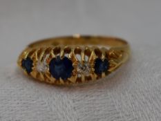 A lady's Victorian dress ring having three graduated sapphires interspersed by two diamonds in a