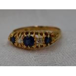 A lady's Victorian dress ring having three graduated sapphires interspersed by two diamonds in a