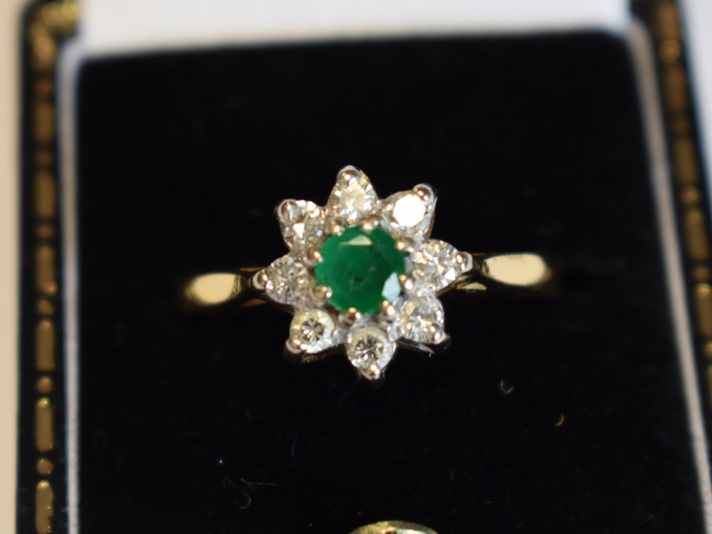 A lady's dress ring having an emerald and diamond cluster in a claw set mount on an 18ct gold - Image 3 of 8