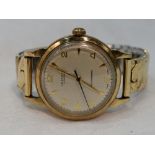 A gents 1960's 9ct gold wrist by J W Benson of London having Arabic numeral and baton dial with