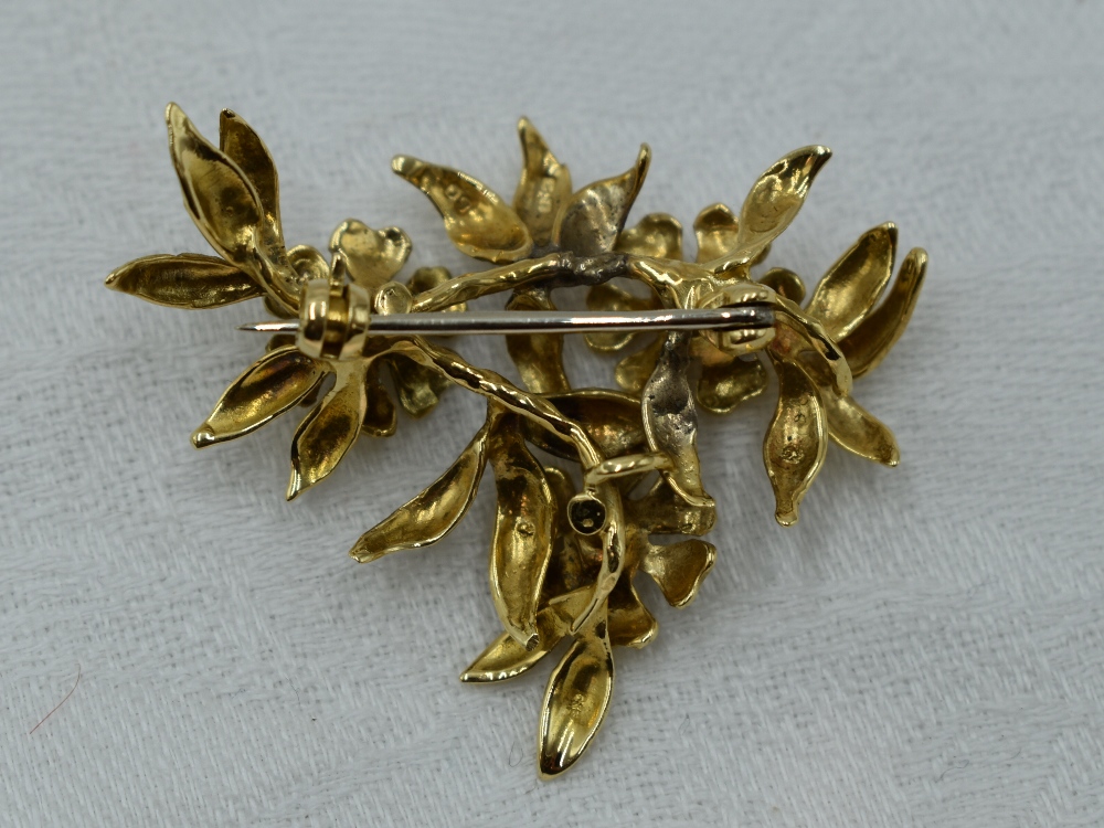 An 18ct gold brooch modelled as a stem of three flowers with diamond centres - Image 2 of 2