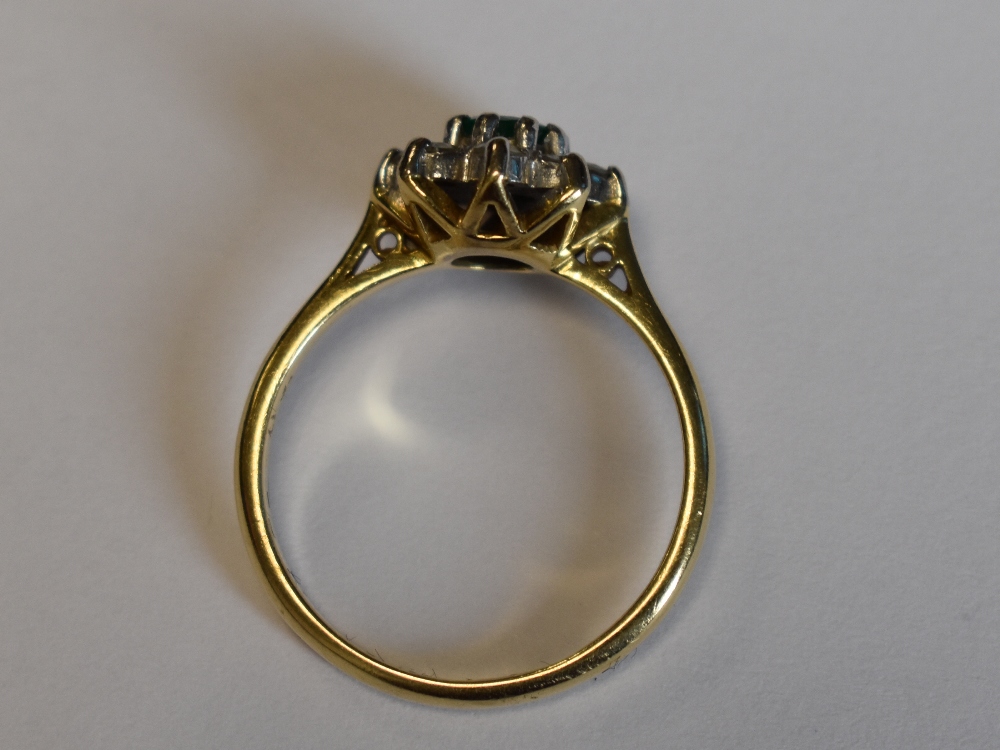 A lady's dress ring having an emerald and diamond cluster in a claw set mount on an 18ct gold - Image 6 of 8