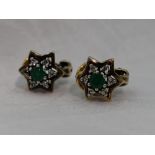 A pair of yellow metal stud earrings stamped 18 having clip style butterfly back, with emerald style