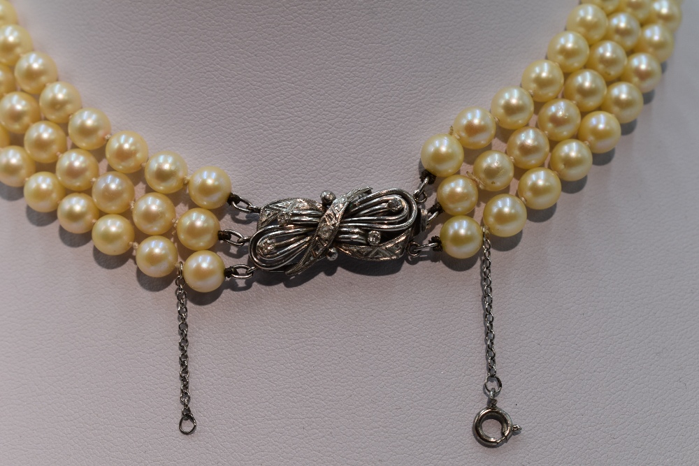 A mid 20th Century triple row cultured pearl necklace, each pearl of even form having decorative - Image 2 of 3