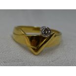 A lady's dress ring of stylised band form having a diamond solitaire approx 0.128ct in a collared