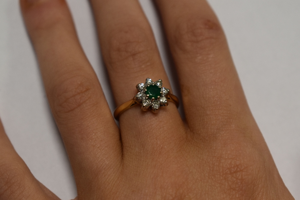 A lady's dress ring having an emerald and diamond cluster in a claw set mount on an 18ct gold - Image 7 of 8