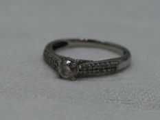 A lady's dress ring having a diamond solitaire, approx 0.25ct in a four claw setting to diamond