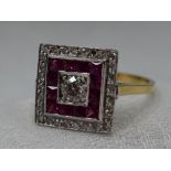 A lady's Art Deco style dress ring of square form having a central diamond, approx 0.33ct within a