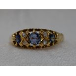 A lady's dress ring having three graduated powder blue sapphires interspersed by four small diamonds