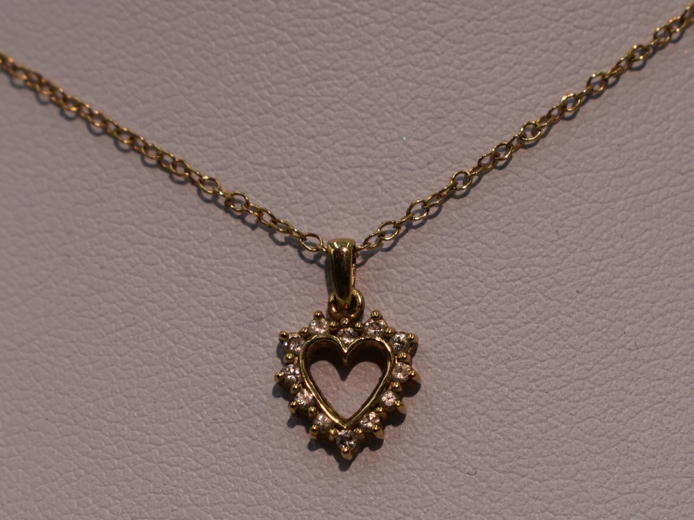 A 9ct gold and diamond open heart pendant on a 9ct gold chain, approx 16'