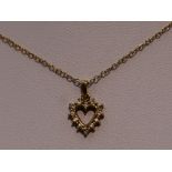 A 9ct gold and diamond open heart pendant on a 9ct gold chain, approx 16'