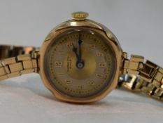 A lady's vintage 9ct gold wrist watch by Buren having an Arabic numeral and gilt dot dial in