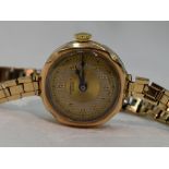 A lady's vintage 9ct gold wrist watch by Buren having an Arabic numeral and gilt dot dial in