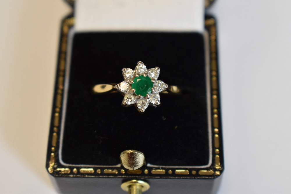 A lady's dress ring having an emerald and diamond cluster in a claw set mount on an 18ct gold - Image 4 of 8