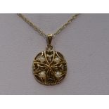 A 9ct gold pendant of pierced circular form having seed pearl decoration on a 9ct gold chain, approx