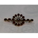 A garnet and seed pearl bar brooch in yellow metal mount stamped 9ct (af)