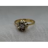 A lady's dress ring having a diamond solitaire, approx 0.128ct in a stylised white and yellow