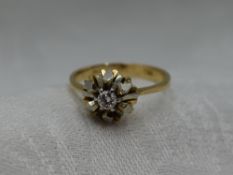 A lady's dress ring having a diamond solitaire, approx 0.128ct in a stylised white and yellow