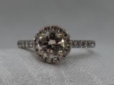 A lady's dress ring having a central diamond, approx 1ct in a four claw mount with diamond set