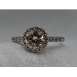 A lady's dress ring having a central diamond, approx 1ct in a four claw mount with diamond set