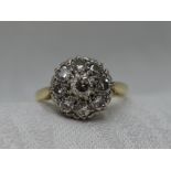 A lady's dress ring having a diamond cluster, total approx 1ct in a pave and claw set mount on a