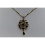 An Edwardian style 9ct gold pendant having central sapphire and diamond cluster in a diamond and