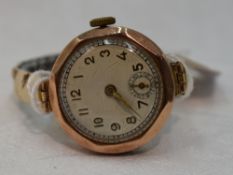 A lady's vintage 9ct gold wrist watch having Arabic numeral dial to circular face in octagonal