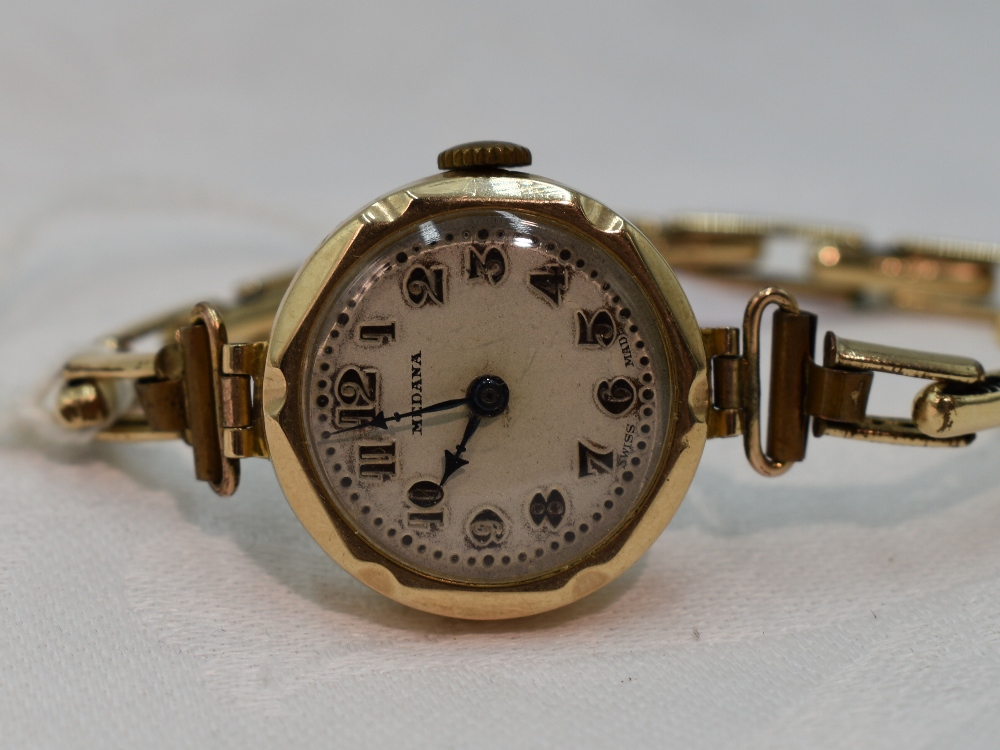 A lady's vintage 9ct gold wrist watch by Medana having an Arabic numeral and gilt dot dial in shaped