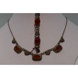 An HM silver necklace having carnelian and marcasite panels on a fixed chain, and a matched HM