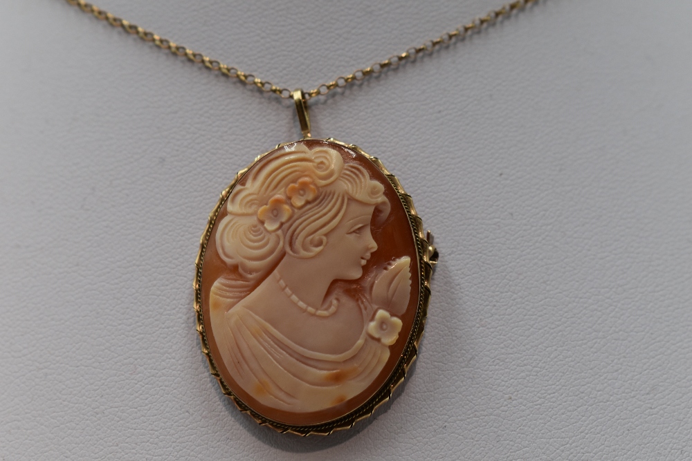 A conche shell cameo brooch/pendant depicting a maiden in profile in a decorative 9ct gold mount