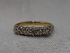 A lady's dress ring having five graduated diamonds, total approx 0.2ct, in an illusionary mount to
