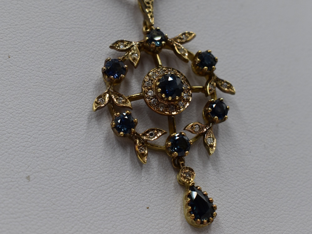 An Edwardian style 9ct gold pendant having central sapphire and diamond cluster in a diamond and - Image 2 of 2