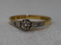 A lady's diamond solitaire dress ring, approx 0.25ct in a decorative claw set mount to diamond set
