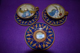 Three decorative studio pottery saucers and two cups, having a lustre finish,possibly attributed