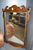 A Chippendale style early 20th century mahogany and walnut wall mirror having gilded beading.