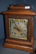 A late 19th century oak cased bracket clock having silver face with roman numerals and striking