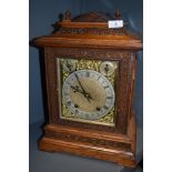 A late 19th century oak cased bracket clock having silver face with roman numerals and striking