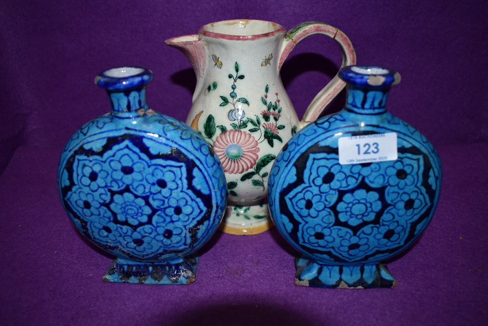 Two vintage azure blue moon flasks with rectangular bases, having floral design, of Isnik style.also