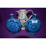 Two vintage azure blue moon flasks with rectangular bases, having floral design, of Isnik style.also